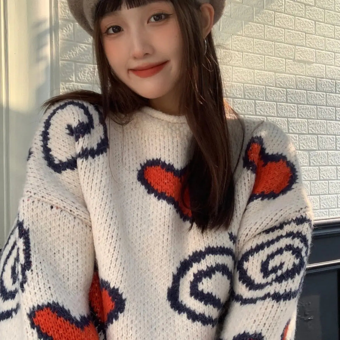 A soft and sweet Korean-style knitted sweater with a heart pattern loose versatile top women autumn and winter season